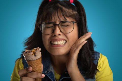 Patient experiencing tooth pain when eating sweets during dental exam in Whittier CA